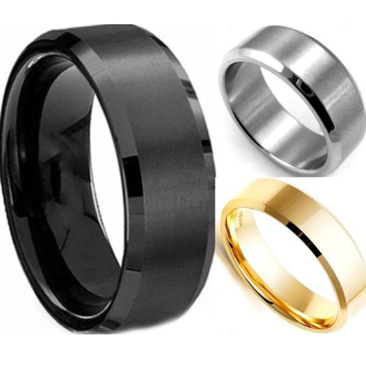 Three titanium rings in black, silver, and gold colors, displayed with a brushed finish.